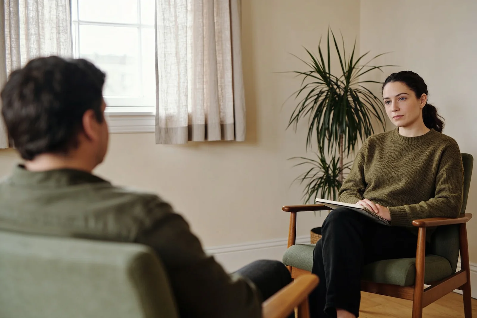 Two people sitting in a calm room during a Solution Focused Hypnotherapy session